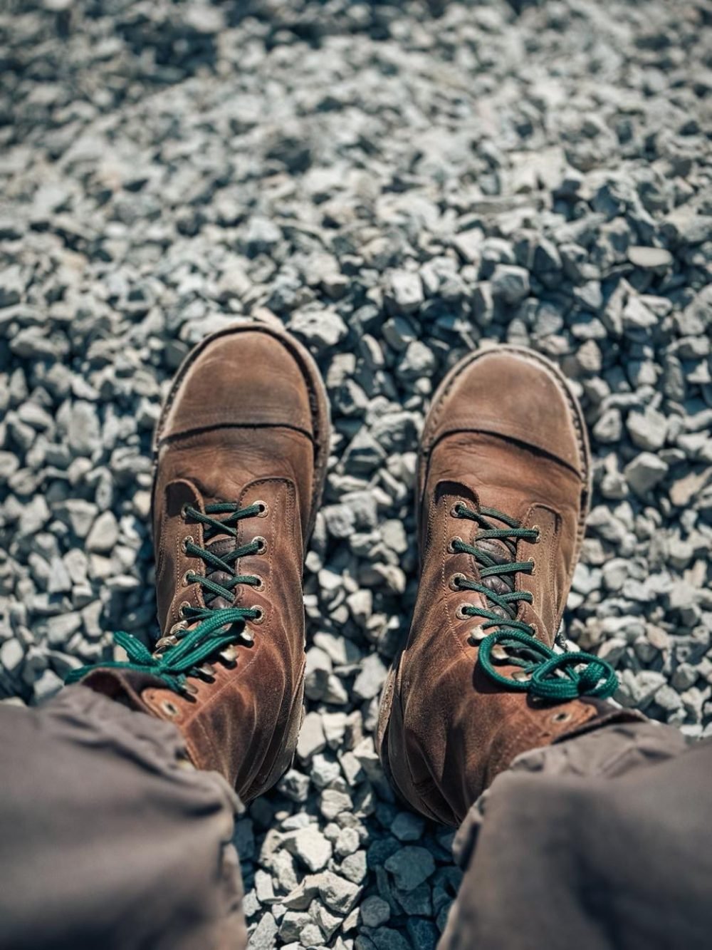 Adventure guide boots dusted from dirt roads and river crossings