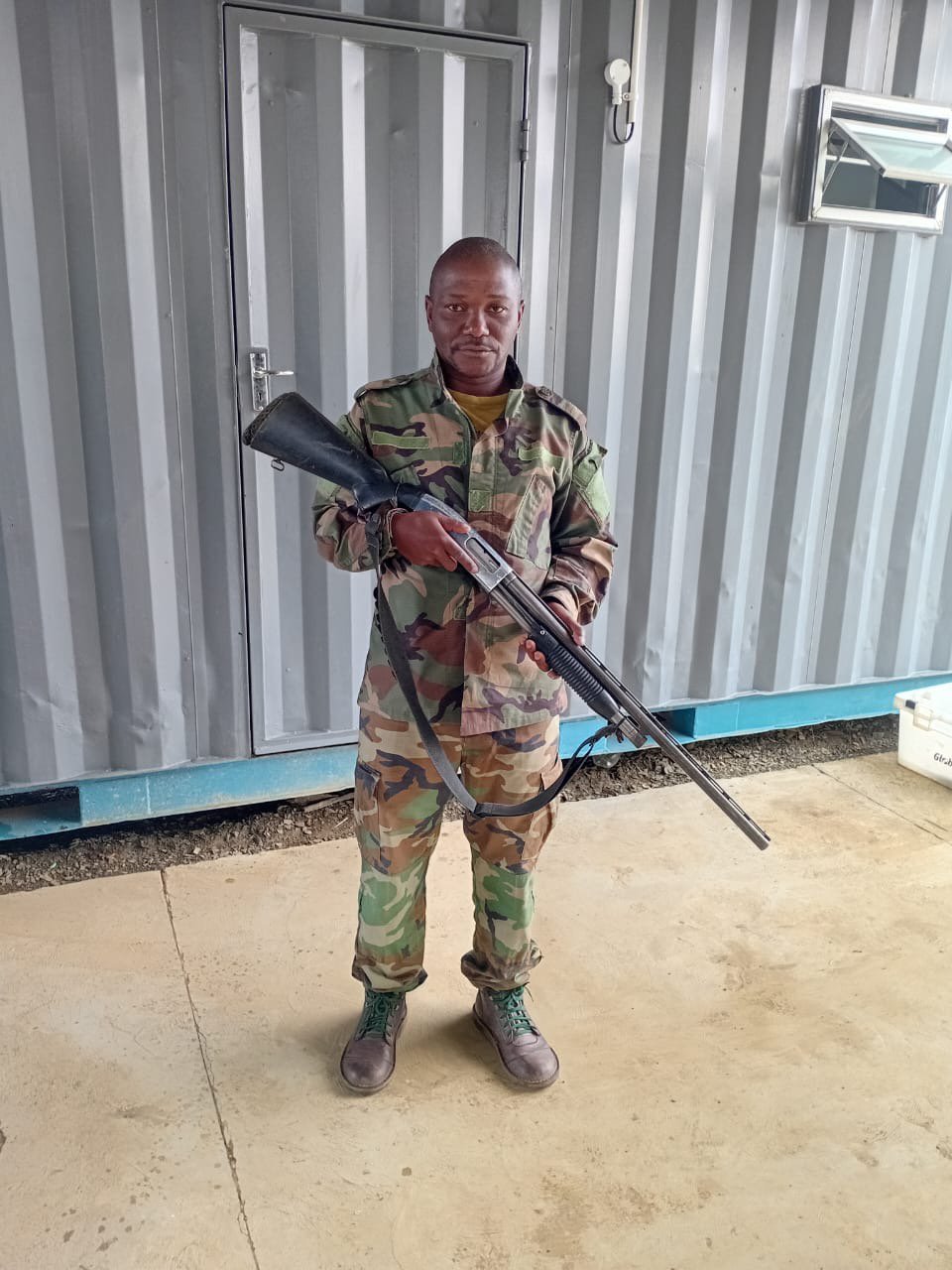 Nambiti anti-poaching ranger holding a shotgun at base