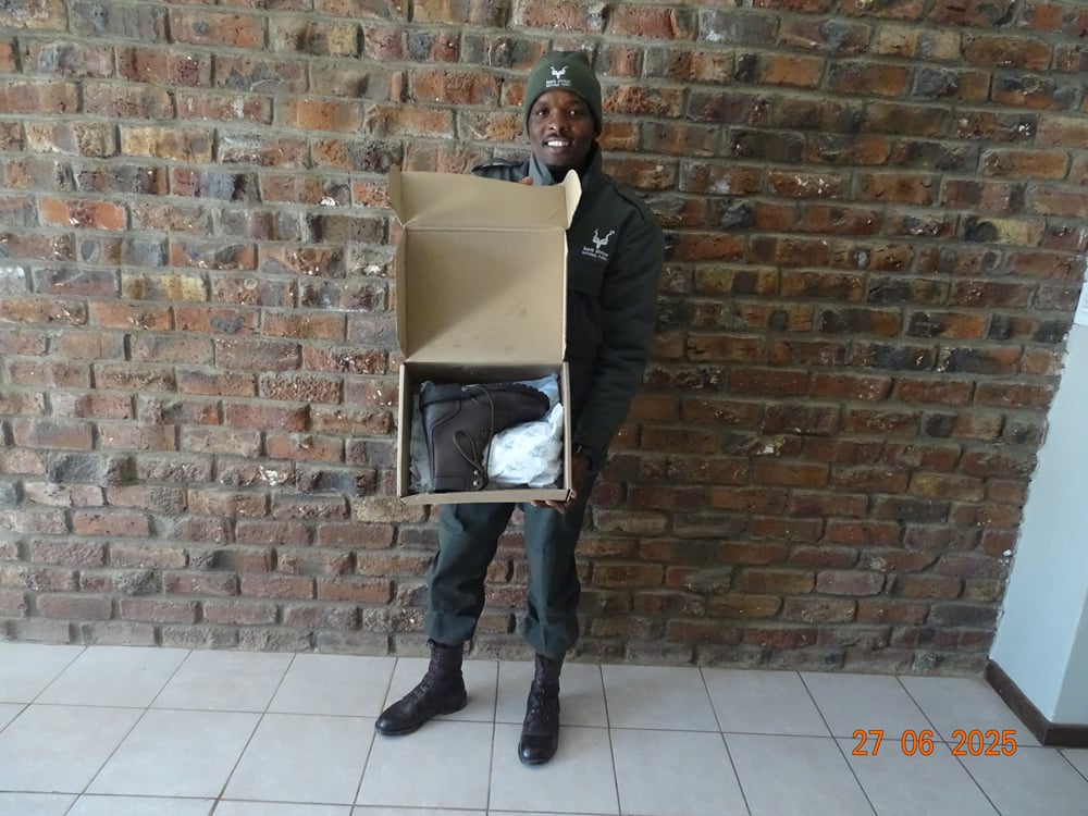 A ranger proudly holding a new box of Jim Green boots